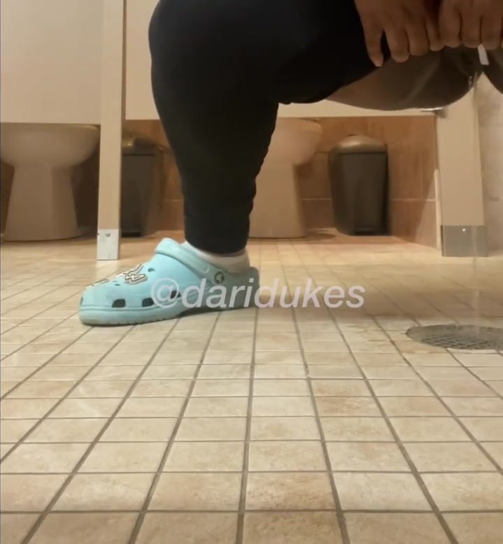 Ebony squat pees over floor drain