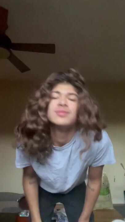 Long haired twink strip tease