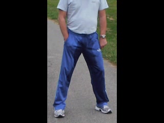 Walking and piss in trackies.