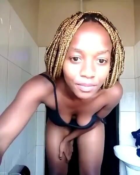 Cute African babe pissing at home