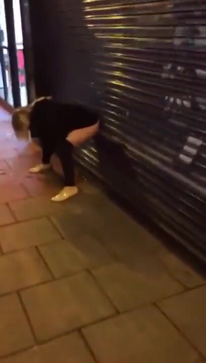 Drunk blonde falls down trying to piss