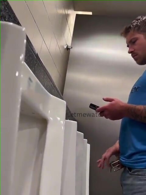 young guy with thick cut dick pissing at urinal
