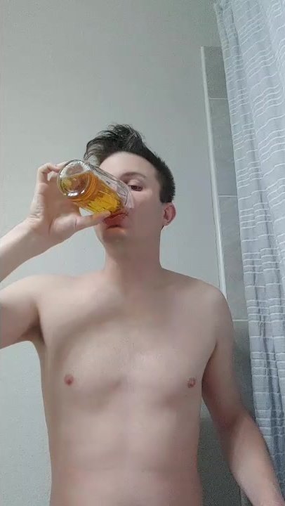caged boy pissing in a jar and drinking it