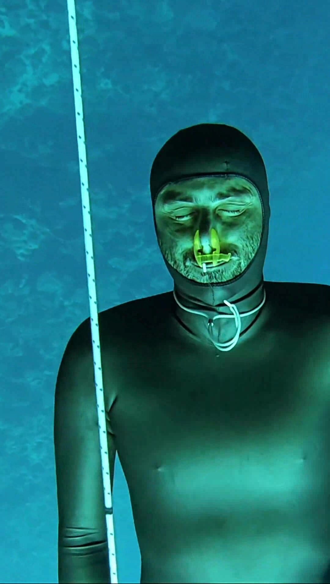 Miguel barefaced underwater in very tight wetsuit