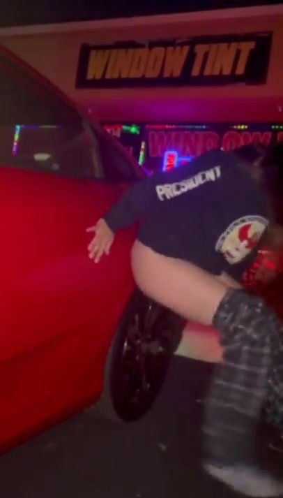 Cute girl films herself peeing leaning against car