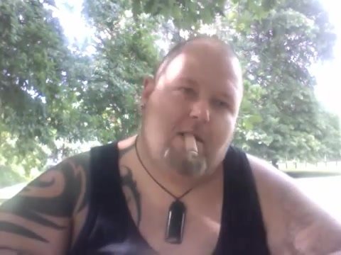 BEAR SMOKES A CIGAR IN THE PARK