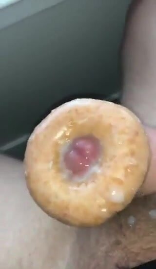 Dude makes a cream filled donut with his cum