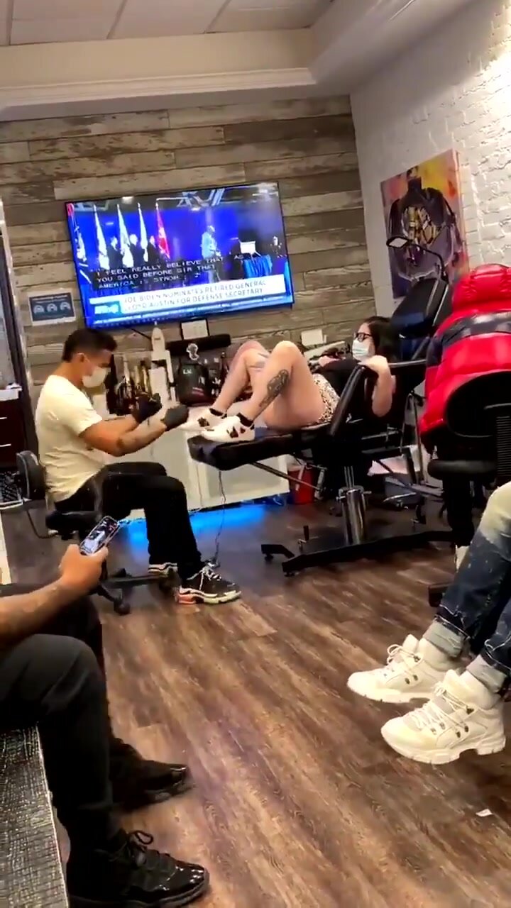 Girl sprays guy doing pussy tattoo