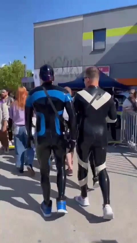 Couple on the street in rubber suit