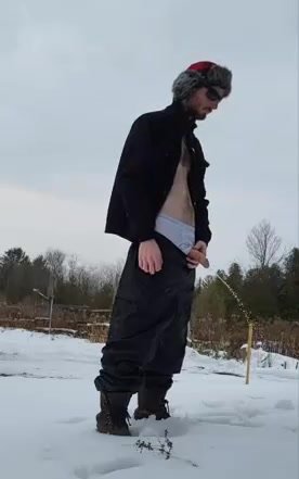 Dude pissing in the snow with a semi