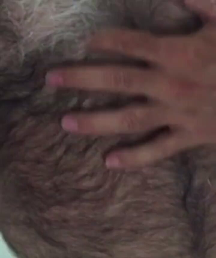 Hairy daddy runs his fingers through his fur