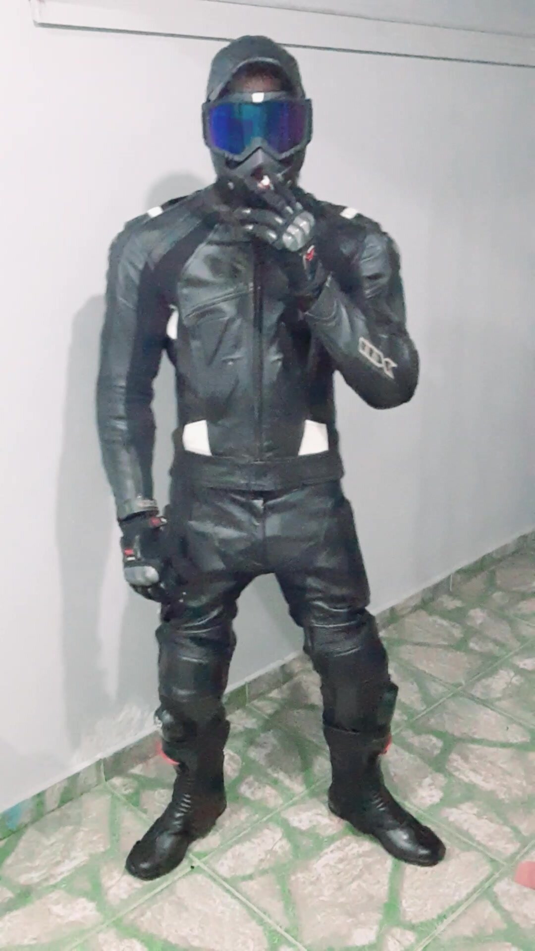 Motorcyclist with protective vest and leather overalls