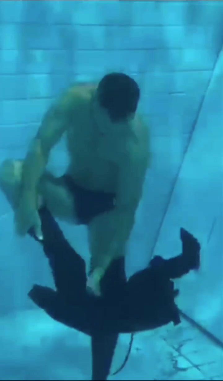 Underwater barefaced freediver from wetsuit to speedo