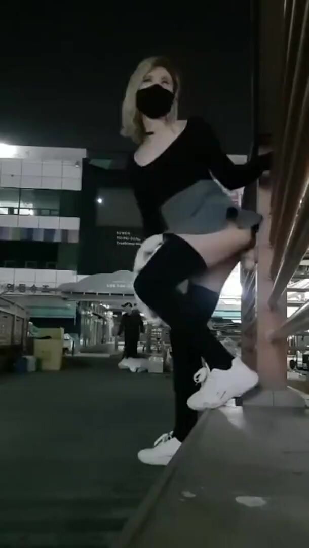 Asian fucks dildo attached to railing in public