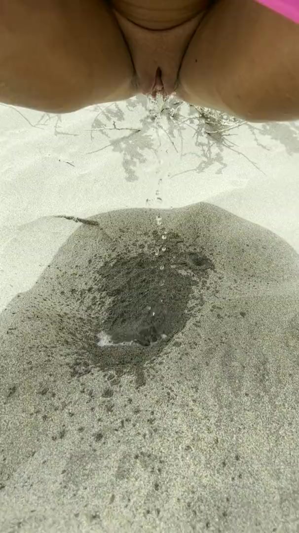 Cute shaved pussy peeing in sand