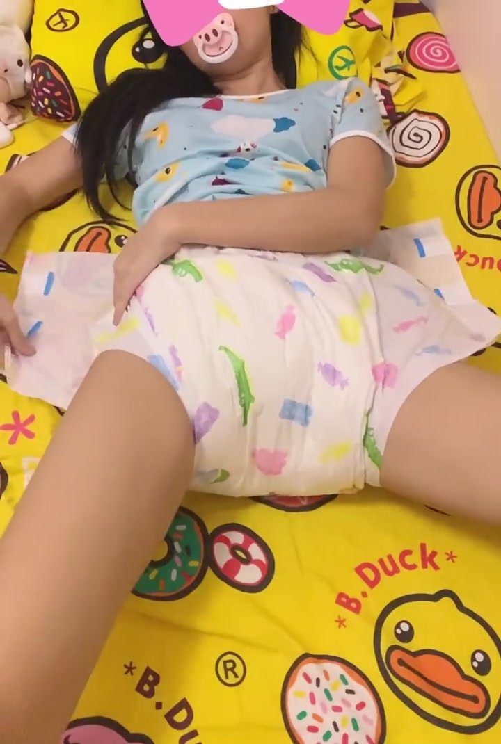 Chinese Girl Putting On Diaper