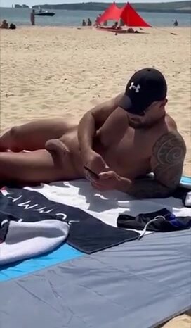 Hot hunk shows off his hard dick on the beach