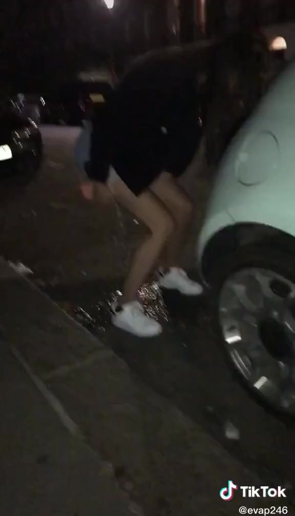 Tict0k slim teen pees behind a parked car
