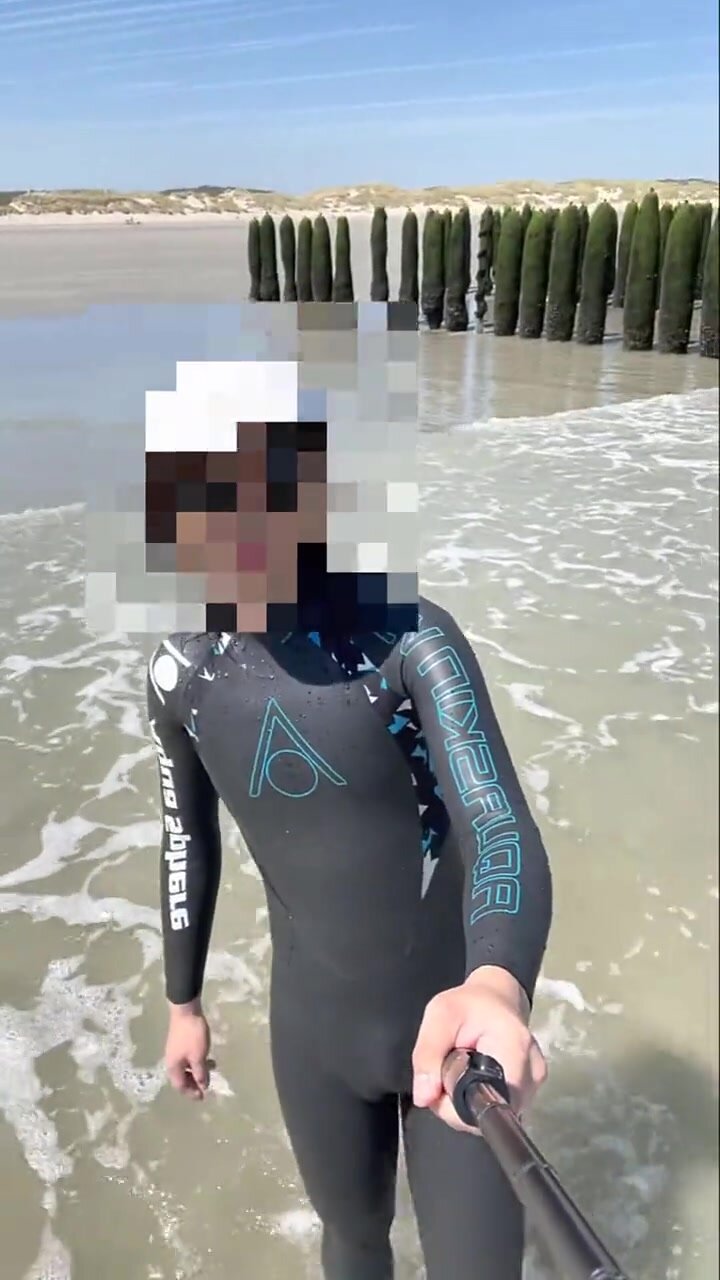 Wetsuit Boy Plays in the sea