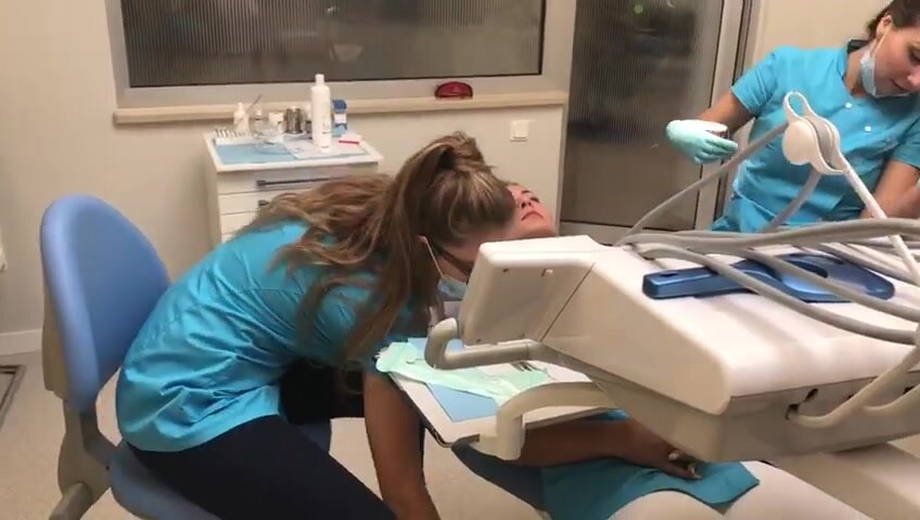 Dentists training on female patient