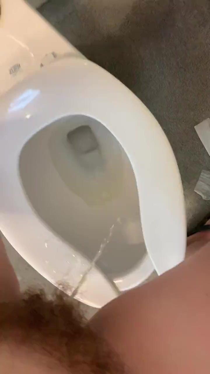 Hairy piss standing over toilet