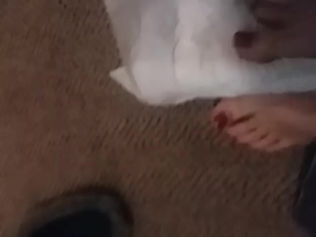 Rubbing her feet on diapers