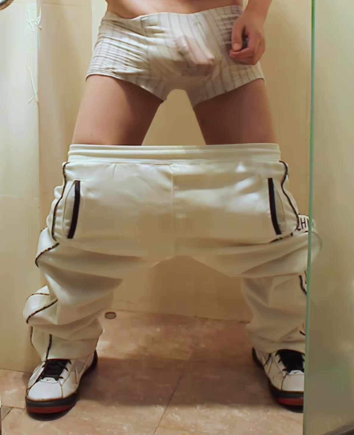 Pissing in white trackies through gray briefs