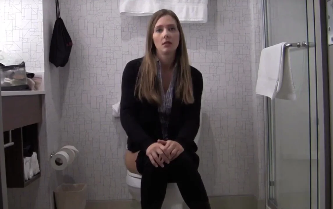 Business women pooping on toilet image