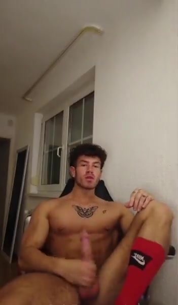 relaxing from chair and stroking his cock