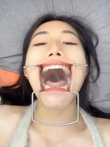 girl w/ mouth gag swallowing