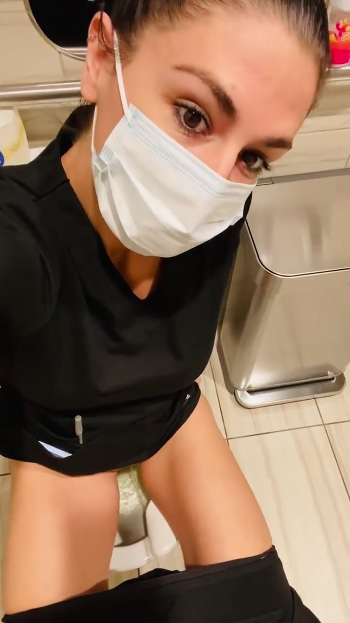 Cute masked babe films herself peeing on job toilet
