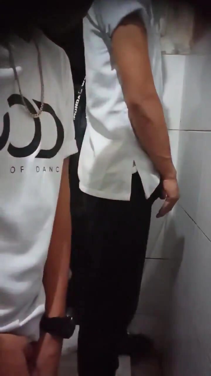 Filipino dudes lining up at the urinal
