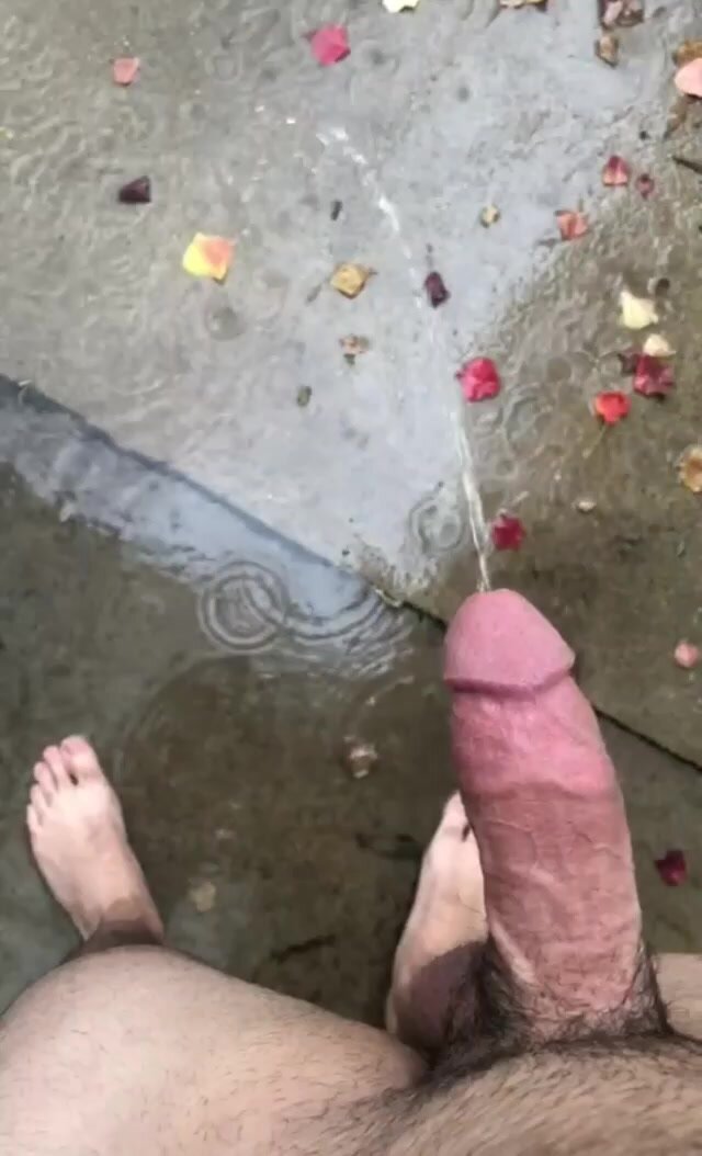 Erect cock pisses handsfree in the rain