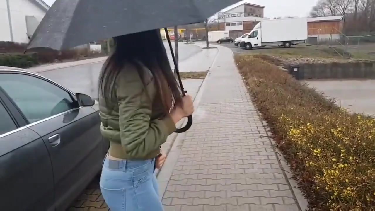 Sexy girl wets her jeans and boots in the rain