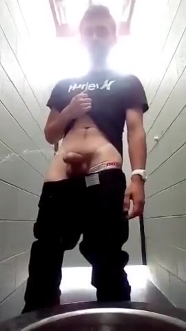 Guy pisses heavily and messily at the toilet