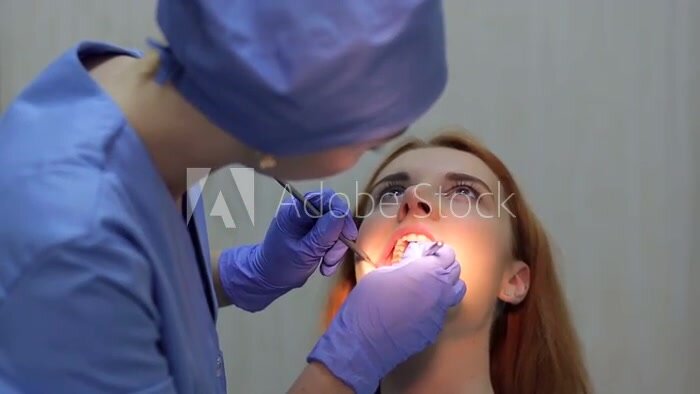 Dental examines teeth female patient - video 2