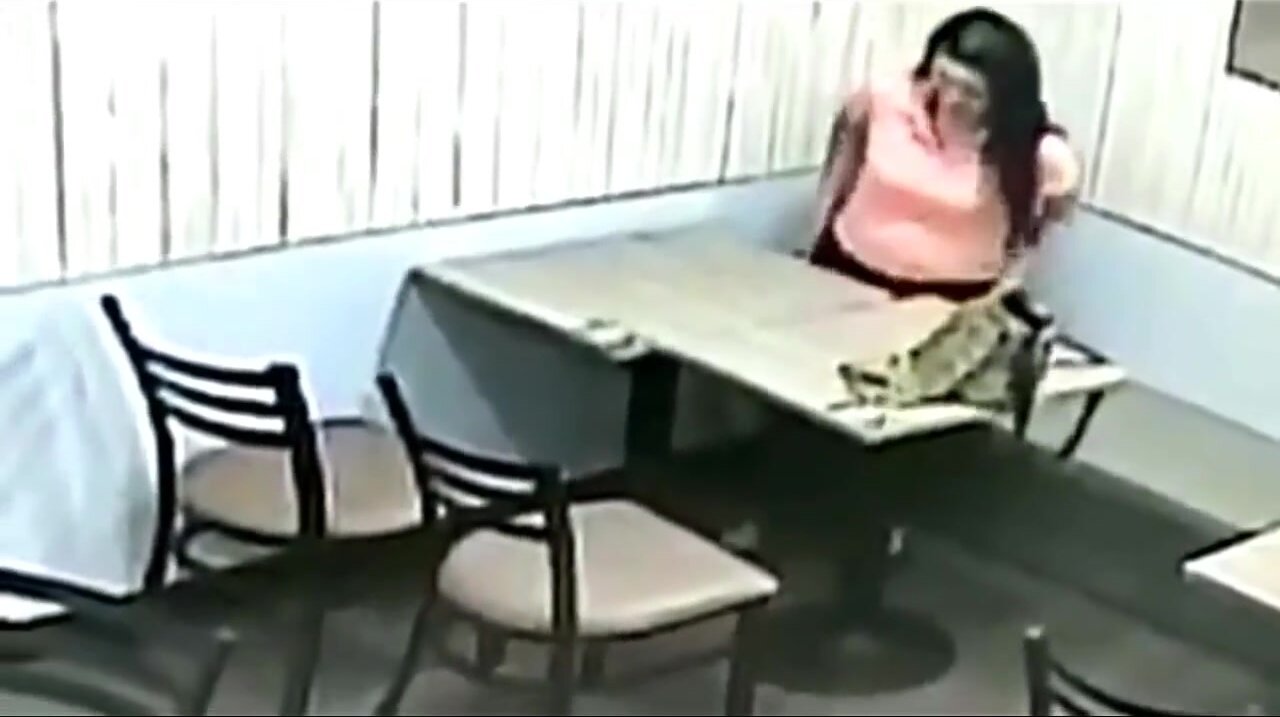 Desperate Girl Caught on CCTV Pissing Under A Table