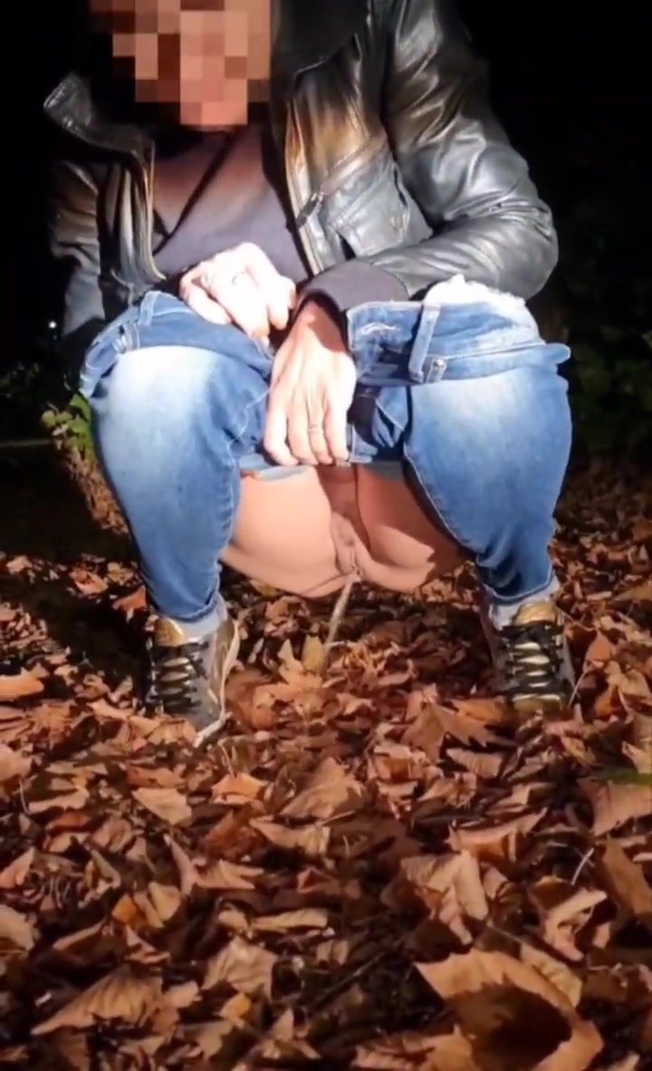Cute blurred face squat pees on leaves in nature
