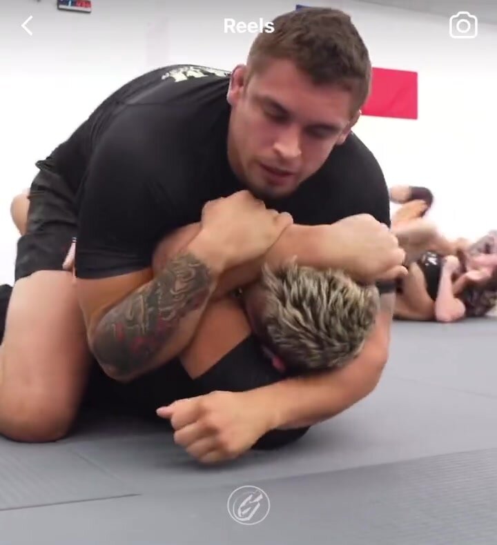 A wrestler coach wipes up the floor