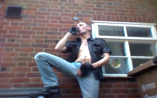 Guy in leather smokes outdoors