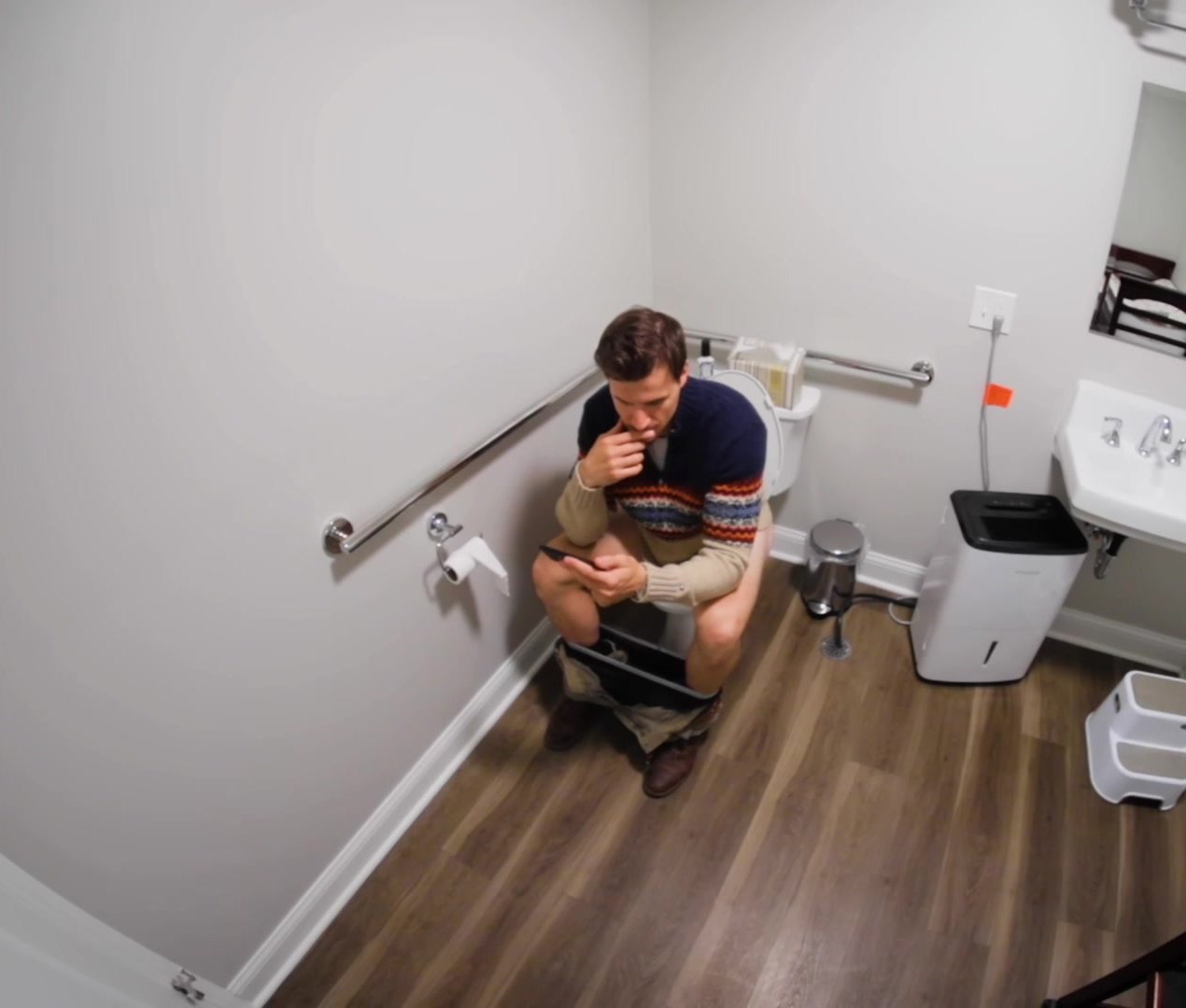 Cute guy sitting on the toilet