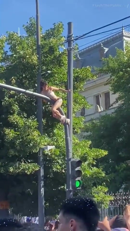 Argentina fan climbs a traffic pole