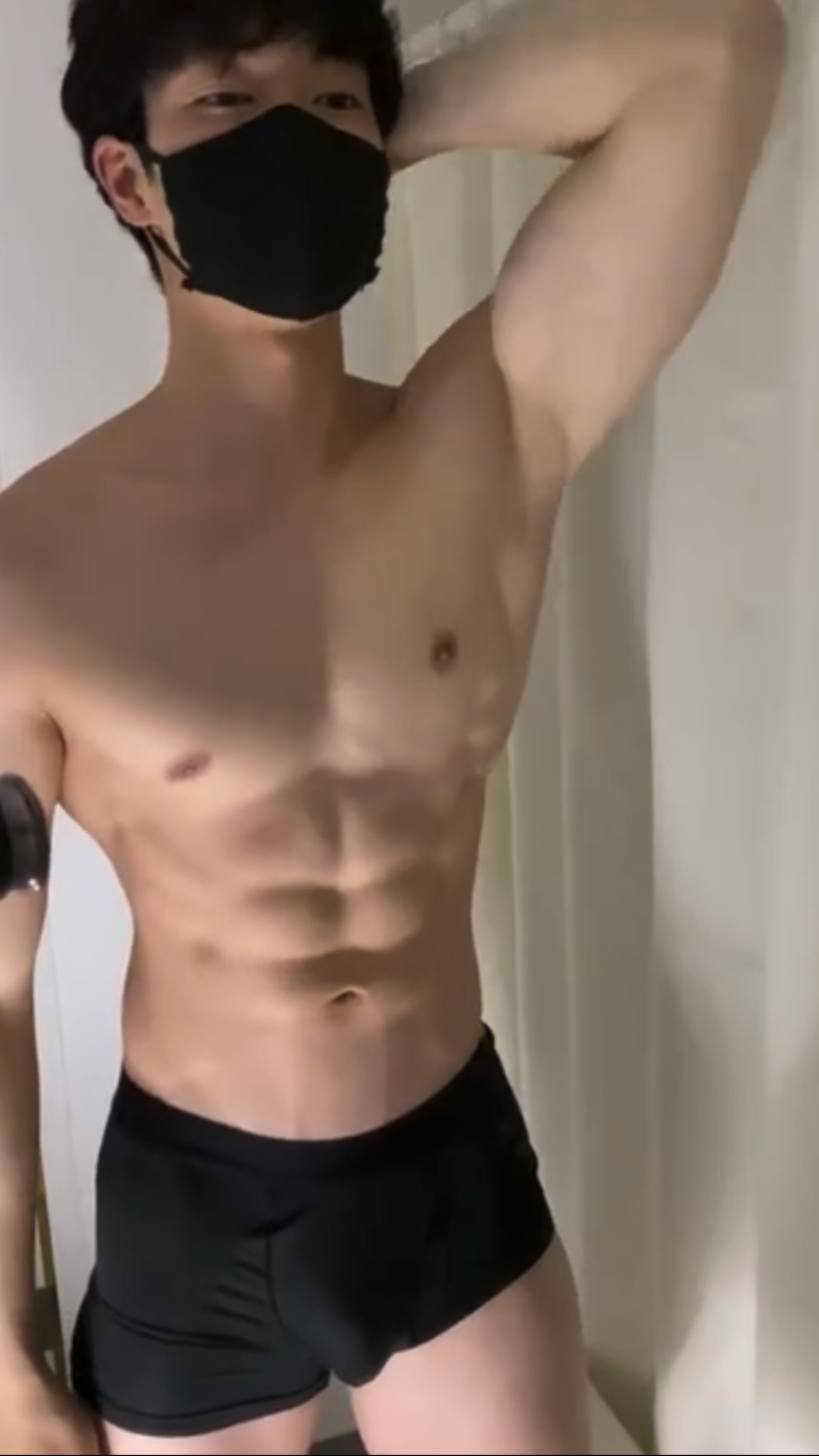 Cute asian guy shows off muscle