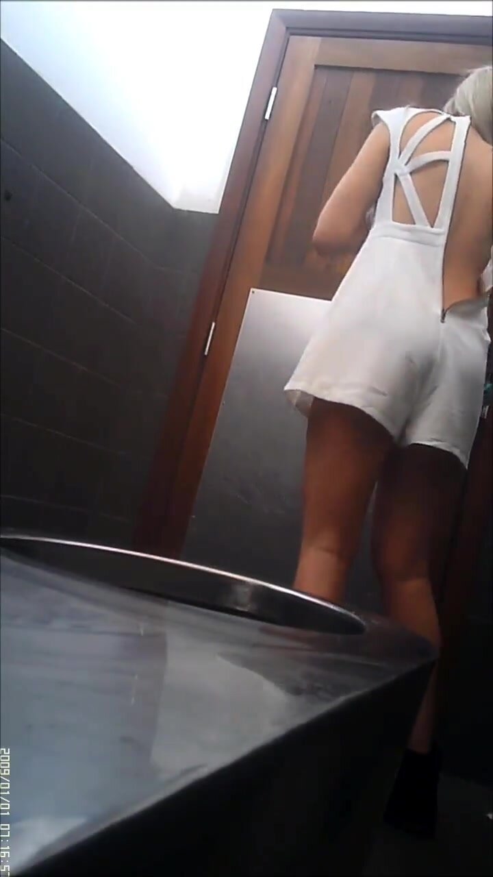 Cute slim babe takes off onesie to public toilet pee