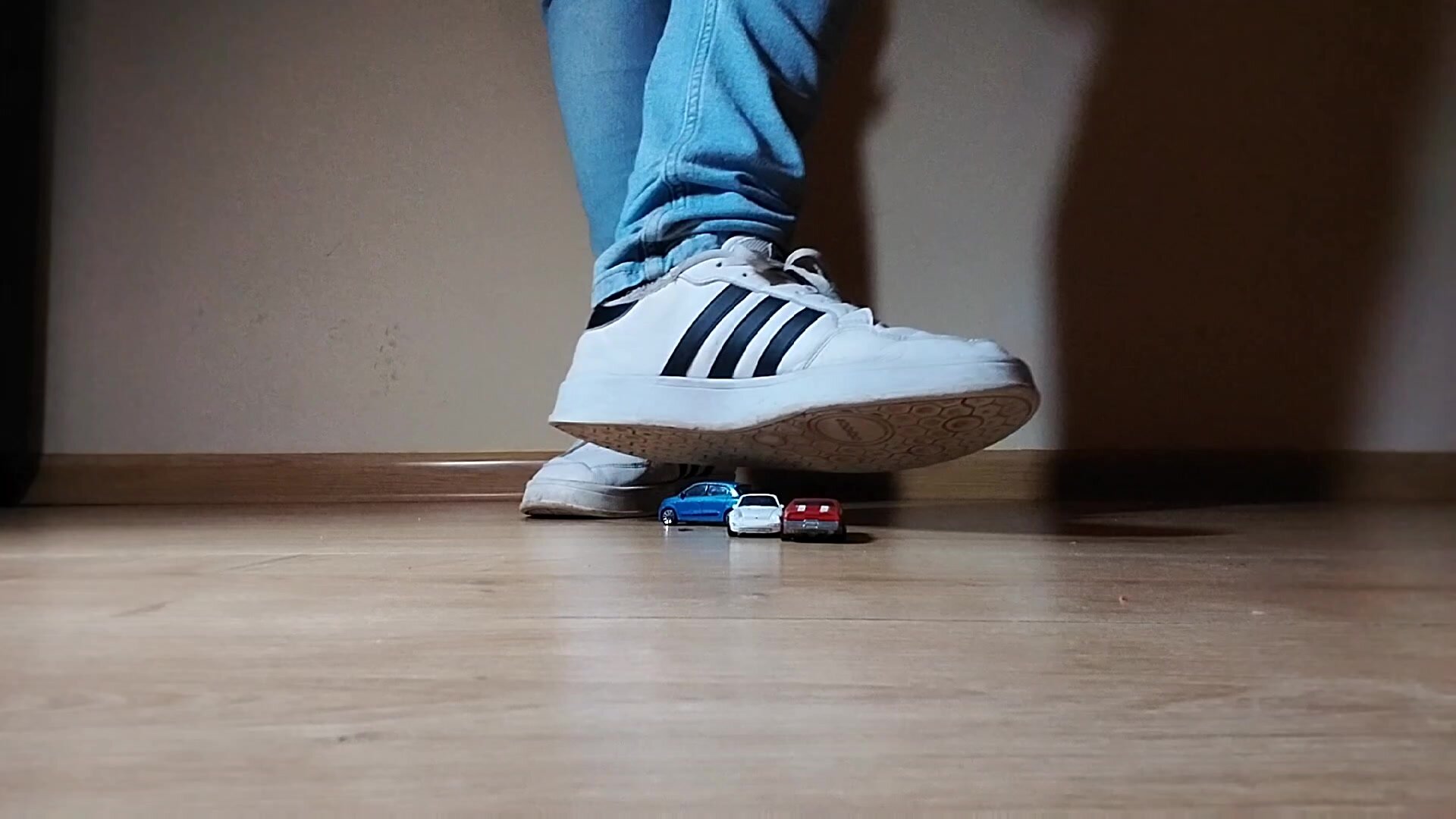 Male giant shoes trampling tiny cars