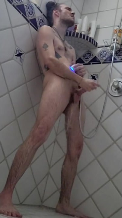 Long haired man cumming in the shower