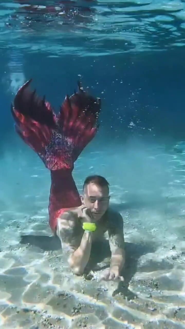 Underwater barefaced tattooed merman