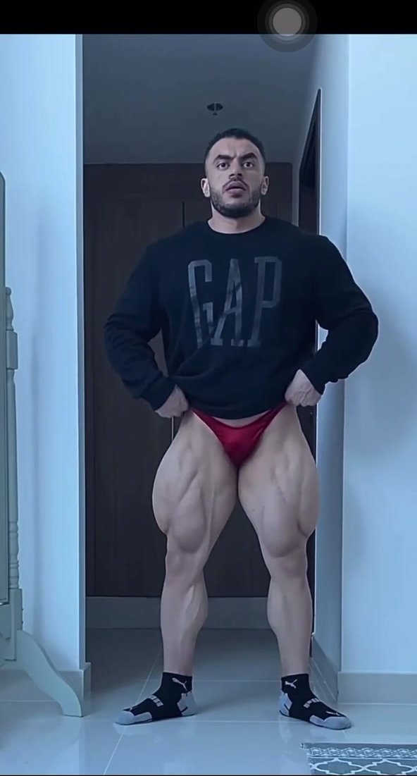extremely hot man with muscular thighs flexing
