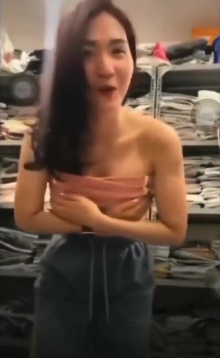 Embarrassed Asian chick accidentally flashes breasts