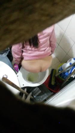 Girl in leggings on toilet